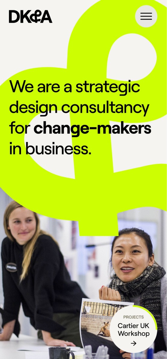 DK&A Example to showcase a mobile web design our agency has created. There is a bright green ampersand and two women smiling in the image. The text on the giant ampersand reads: 'We are a strategic design consultancy for change-makers in business.'